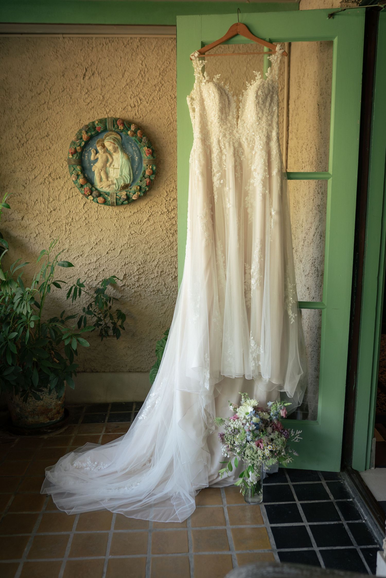 Bridal gown hanging on door
