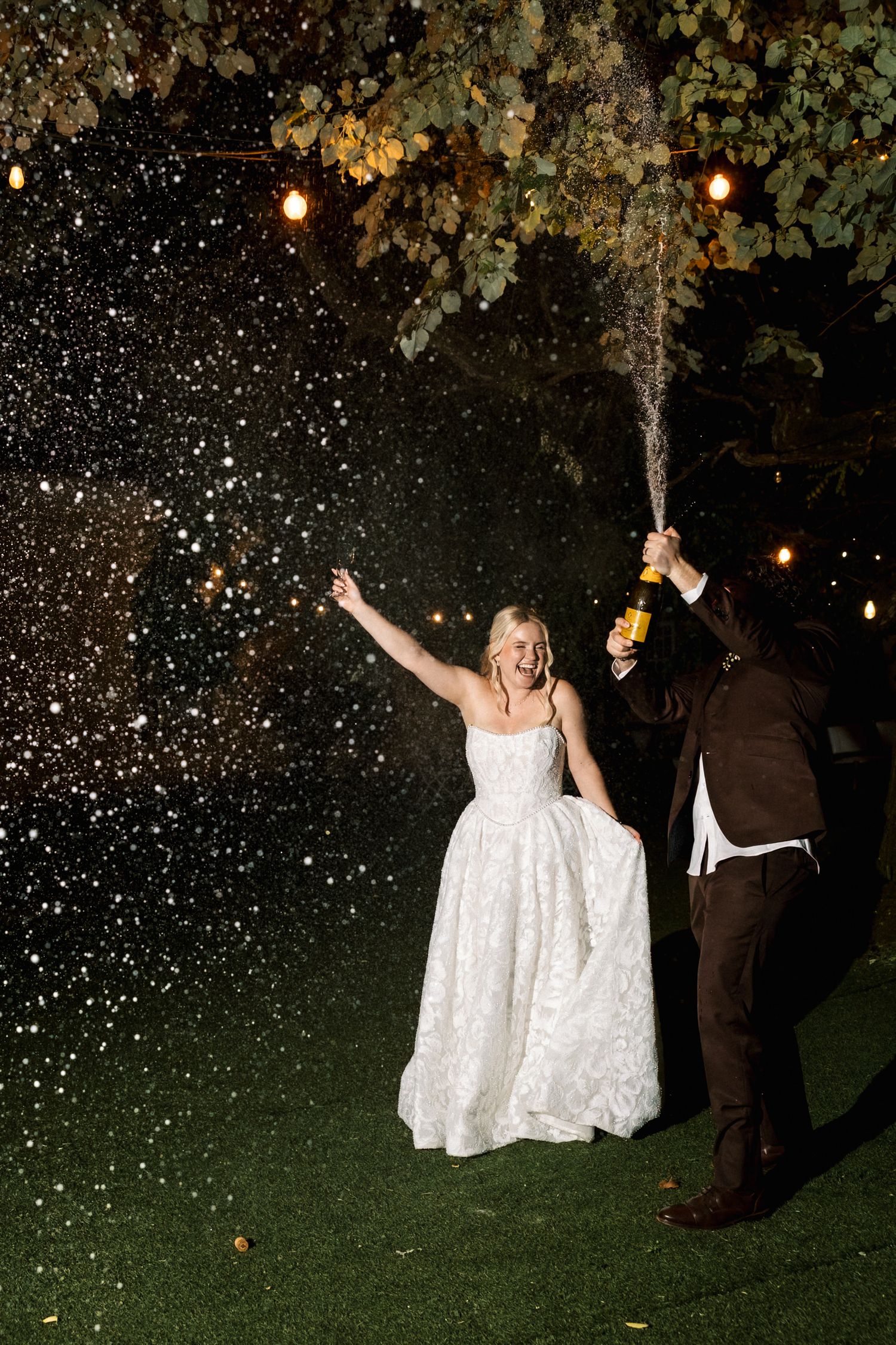 Bride and groom spraying champagne during an intimate wedding in Portugal