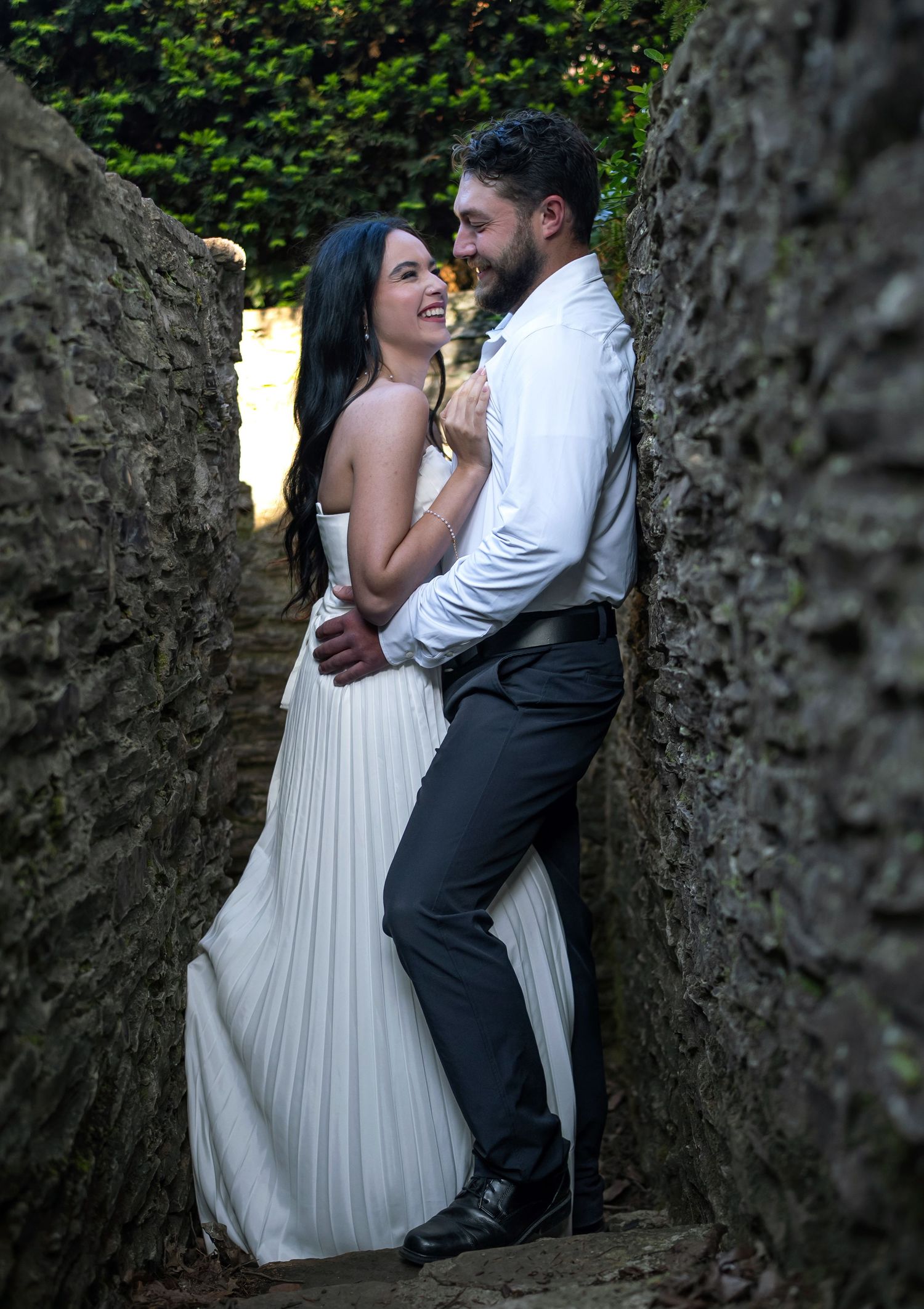 Couple embracing in a stone alleyway at Jeffrey Mansion Engagement Session photo