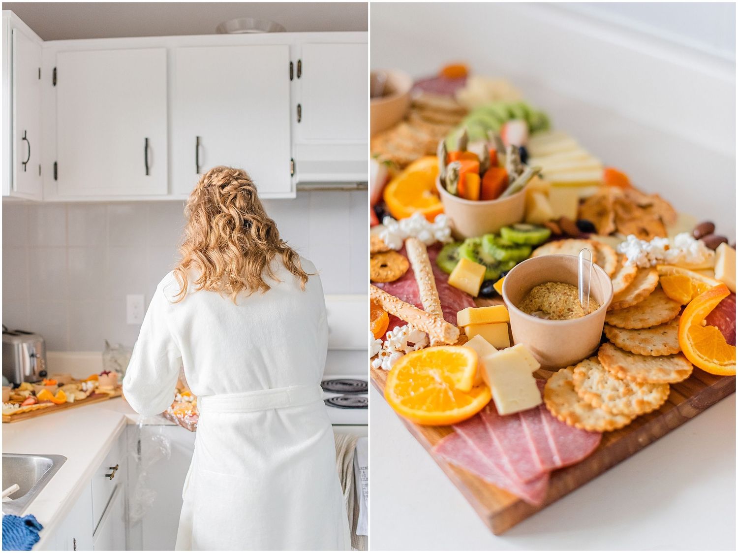 Bride in white robe prepares food beside elegant charcuterie board with fruits and cheeses.