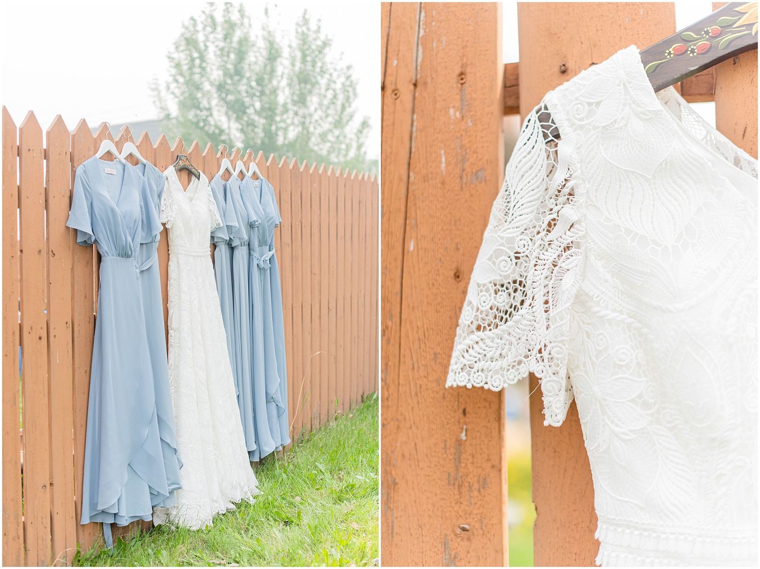 Blue bridesmaid dresses and white lace wedding gown hanging on a wooden fence outdoors.