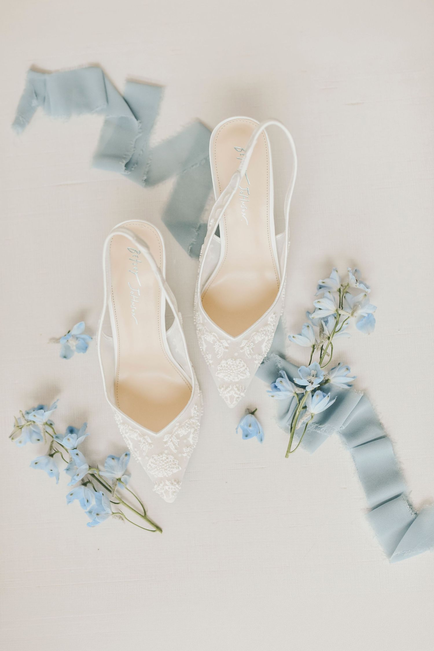 Gardenia venue bridal flat lay with dusty blue palette and elegant textures