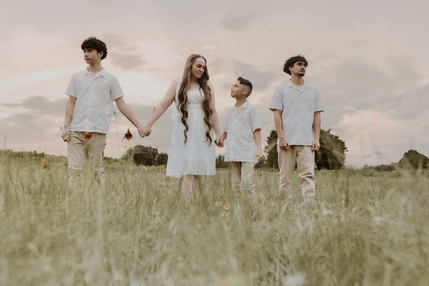 Multi-generational family smiling together during outdoor family photos in Plano