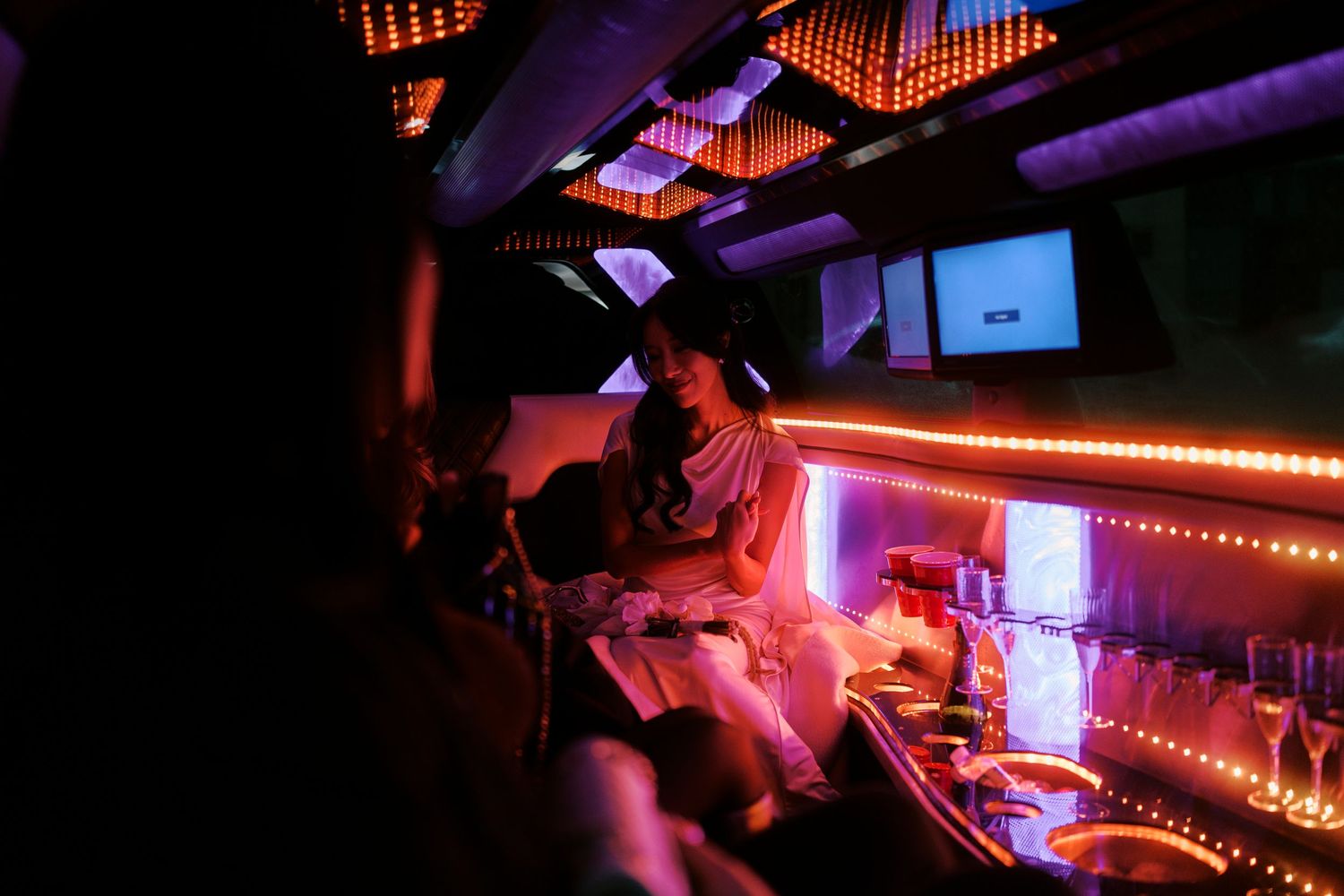 Nightclub scene with neon lighting and people at a bar counter.