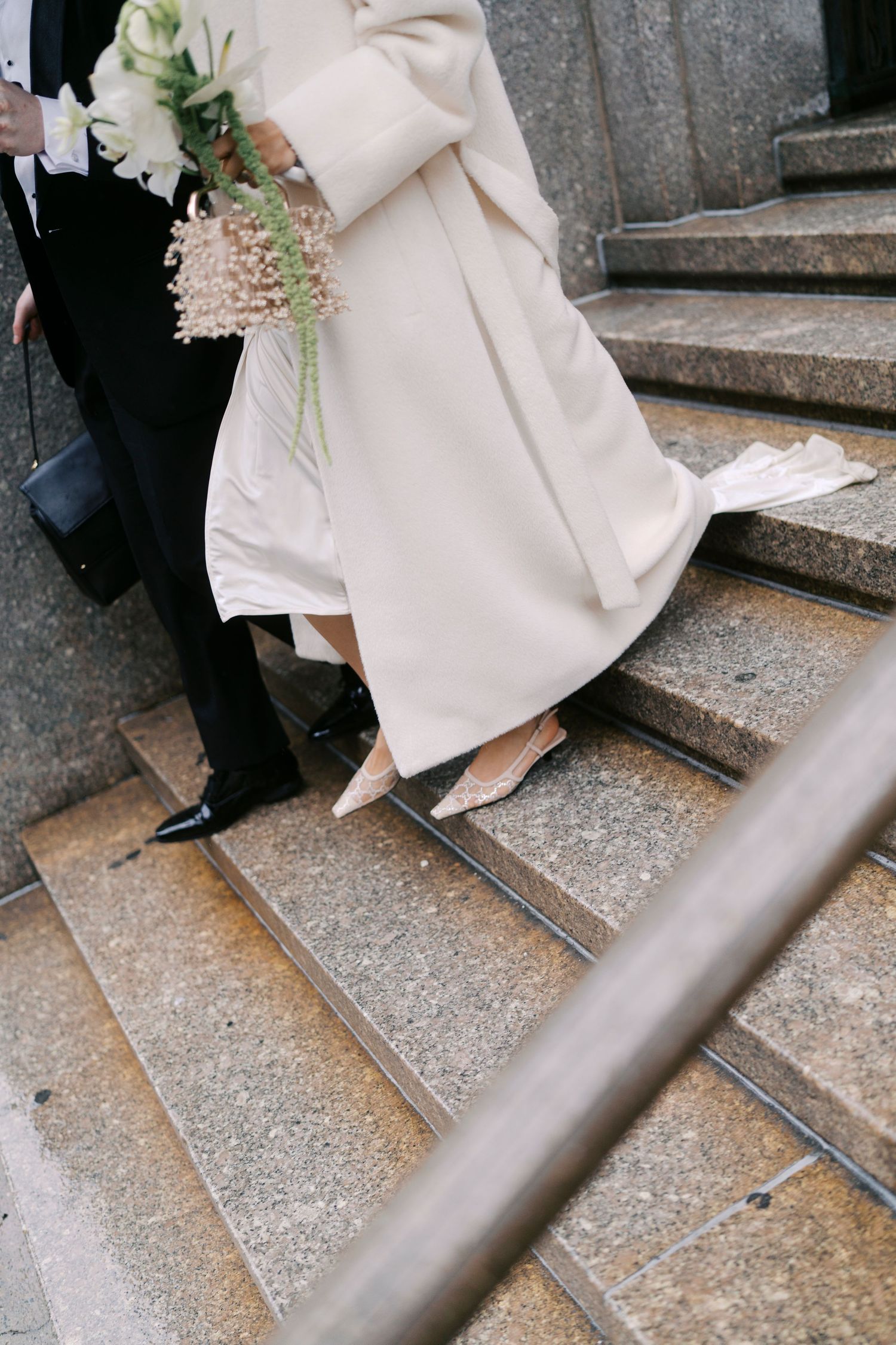 Close-up shots of wedding attire and shoes descending concrete steps in sequence.