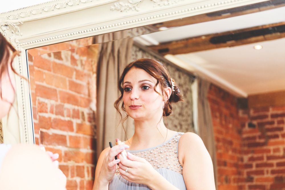 An elegant room with exposed brick walls and ornate white crown molding.