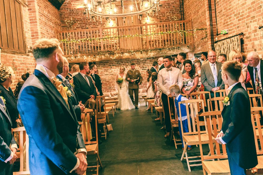 Outdoor celebration scene with string lights and brick wall backdrop.