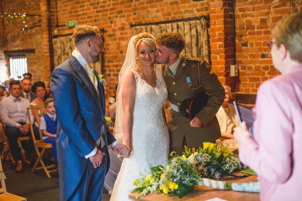 Wedding celebration in a rustic brick venue with warm lighting and festive atmosphere.