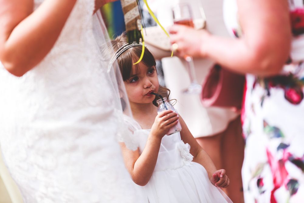 Blurred festive celebration scene with confetti and white attire.
