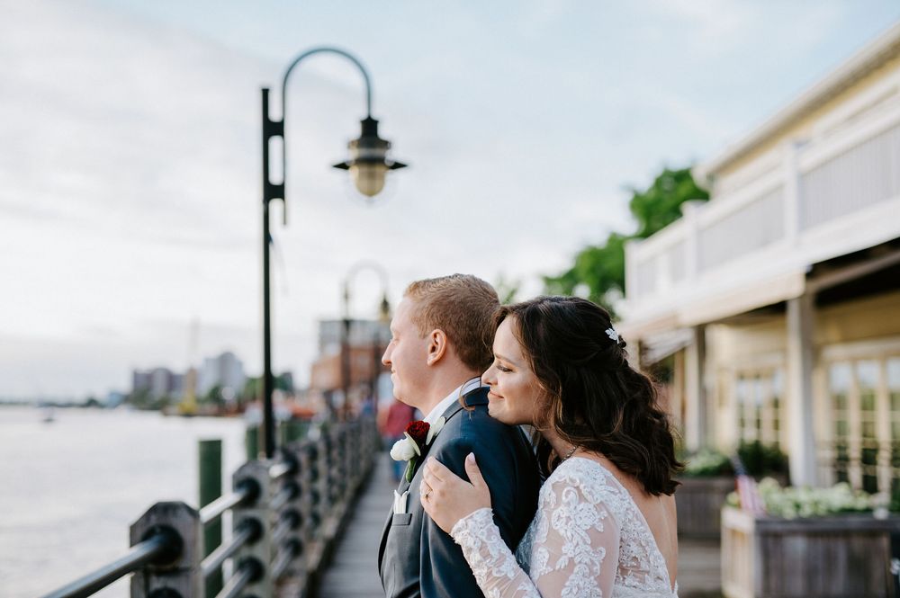 Elegant wedding couple shares romantic moments in multiple outdoor settings with classic architecture and natural backdrops.