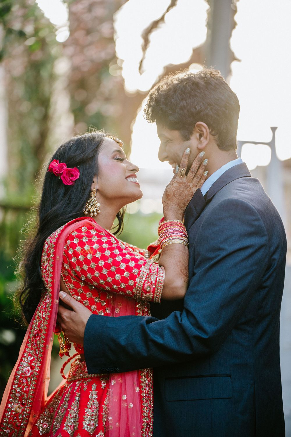 A romantic sequence of three photos showing a couple in traditional Indian wedding attire sharing an intimate moment outdoors.