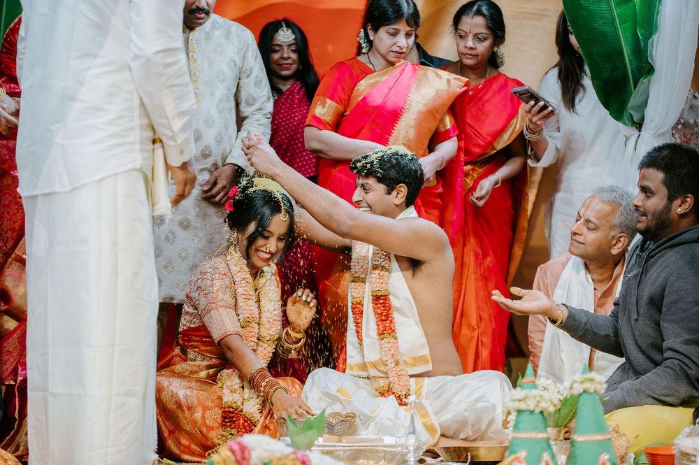 Traditional Indian wedding ceremony with guests gathered around as rituals are performed on a decorated stage.