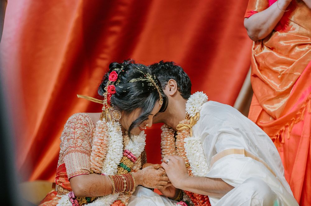 Close-up of a traditional Indian wedding ceremony with red and orange decorative elements.