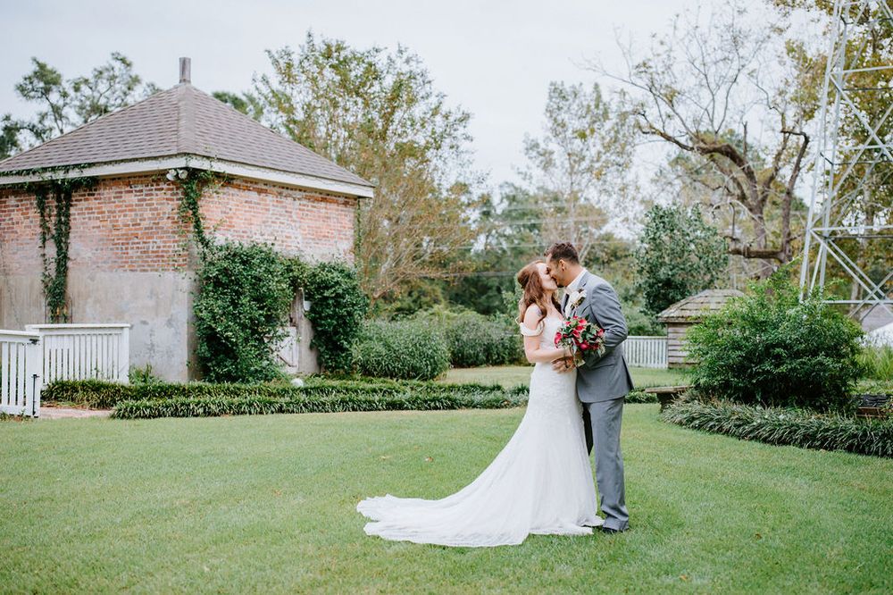 A wedding couple shares intimate moments in a scenic garden setting with lush greenery and natural light.