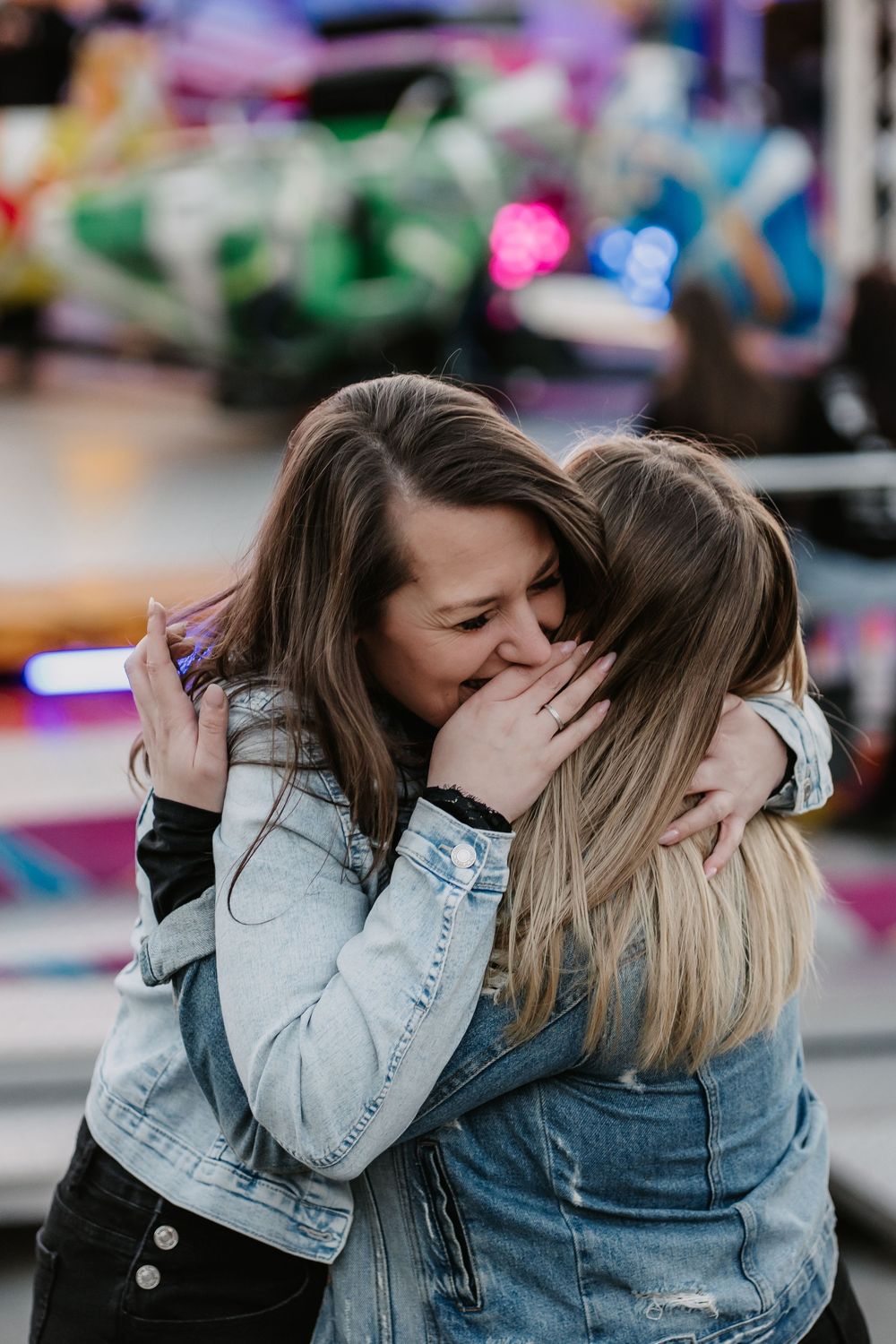 Two friends in denim jackets share an emotional embrace in a series of candid photos.