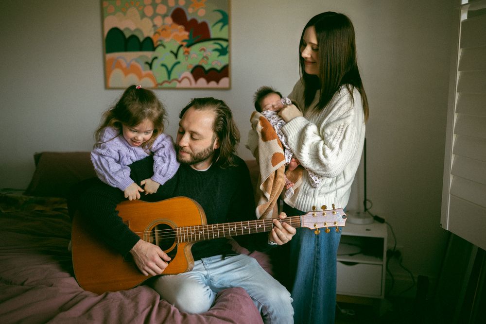 A series of candid moments showing people playing guitar and sharing intimate conversations in a dimly lit room.