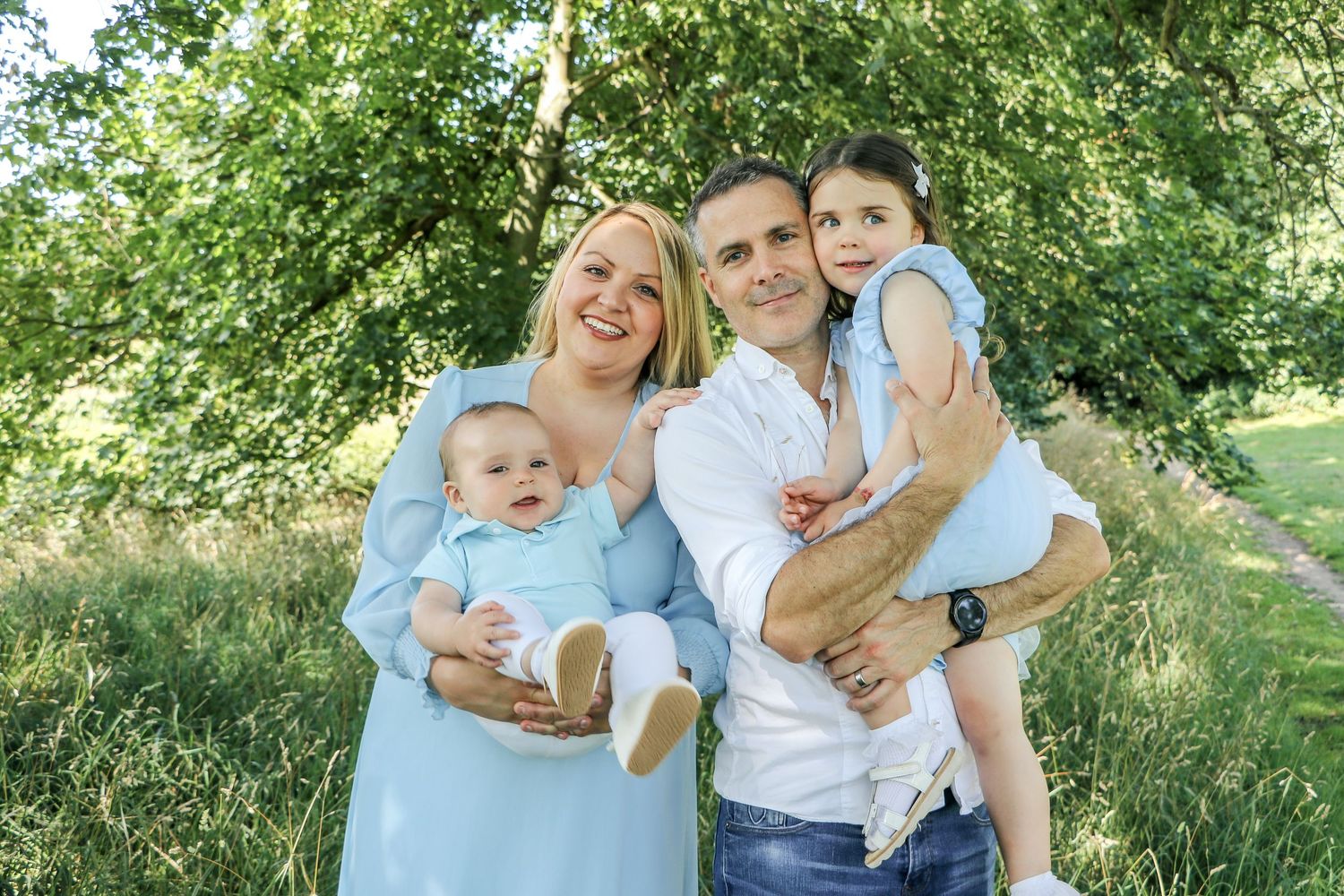 A group enjoying a sunny summer day together in a lush green outdoor setting.
