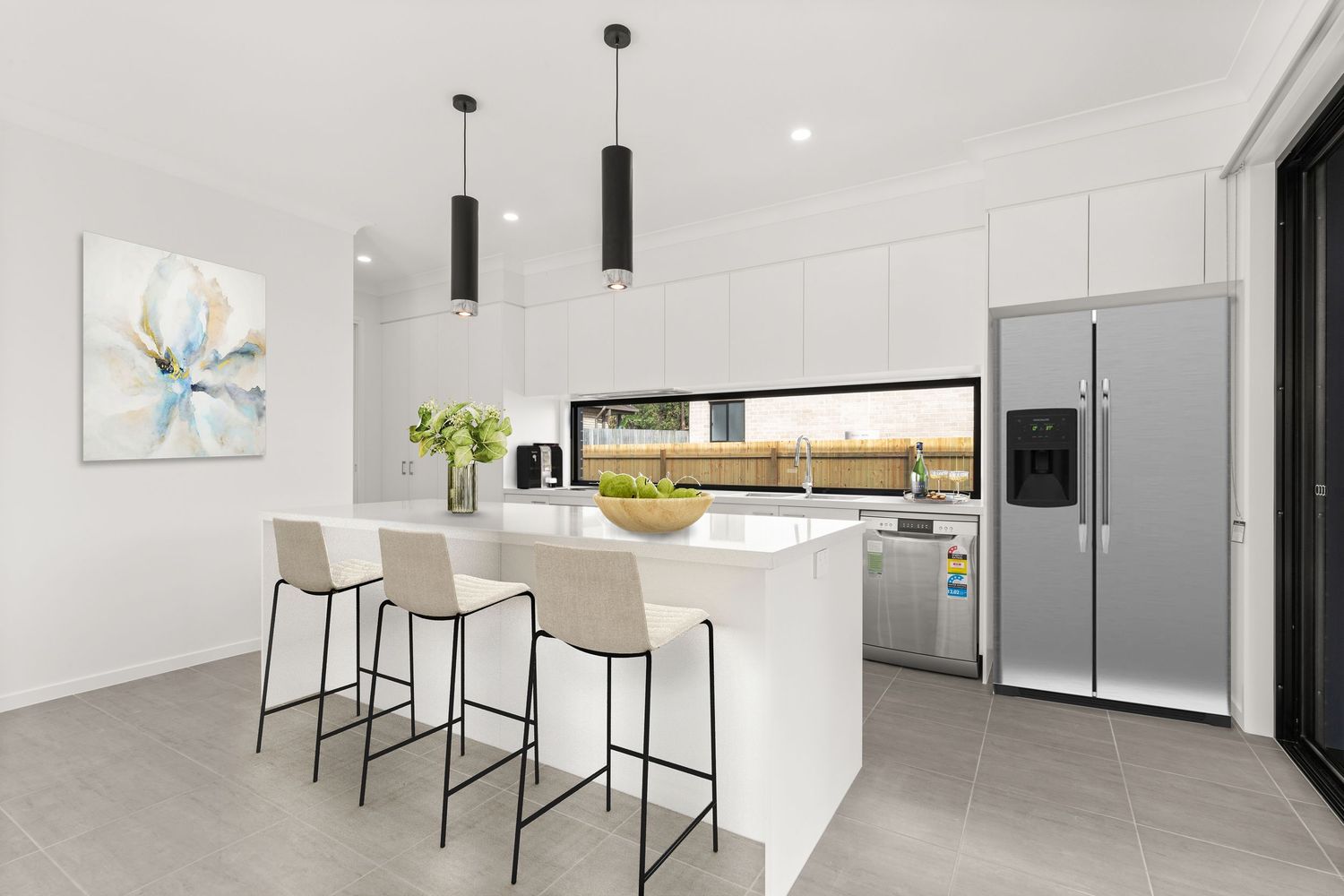 Modern white kitchen with island bench, bar stools, pendant lights, and stainless steel fridge.