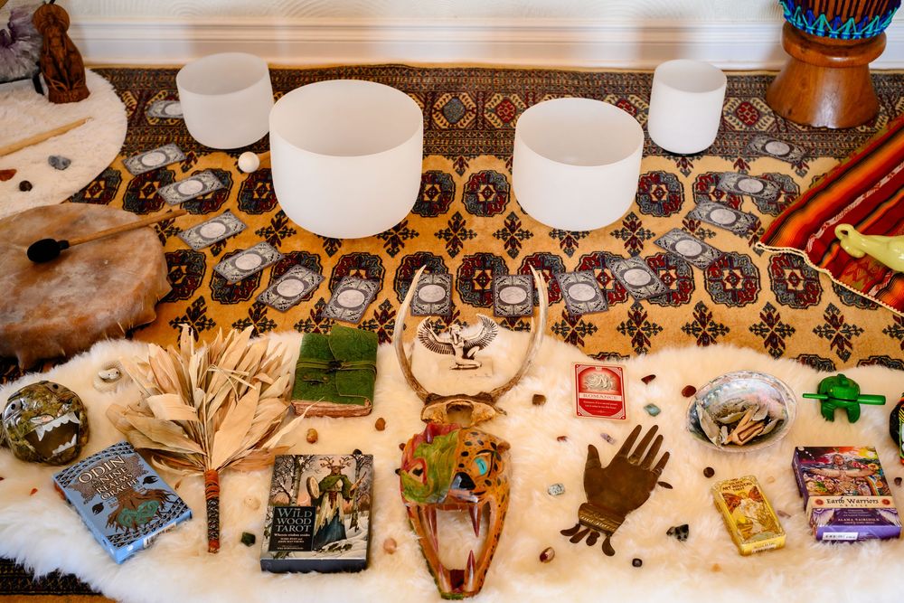 Assorted handmade masks and decorative items displayed on a wooden table at a craft market or artisan fair. Branding photography Las Vegas