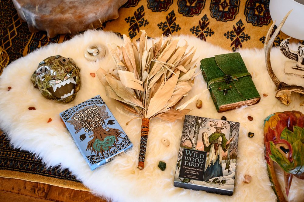 Vintage artifacts and antique accessories arranged on a cream-colored surface with decorative white fur accents. Branding photos Las Vegas