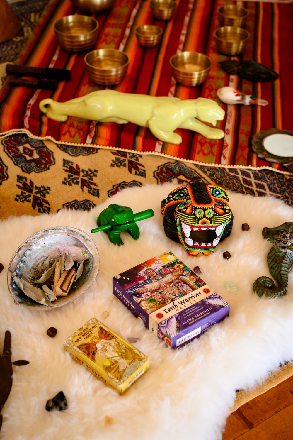 Sacred artifacts and divination tools on a white surface with a striped red background. Branding photography Las Vegas