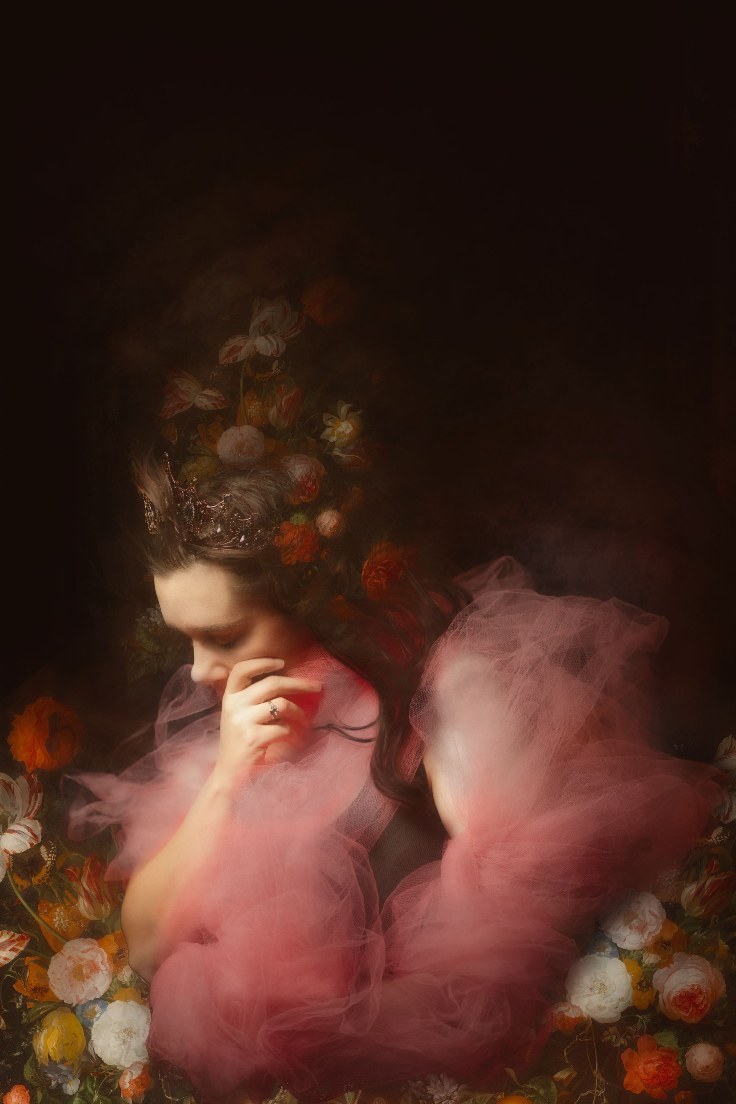 Creative dreamy fantasy painterly fine art photograph of a woman with flowers and a black background.