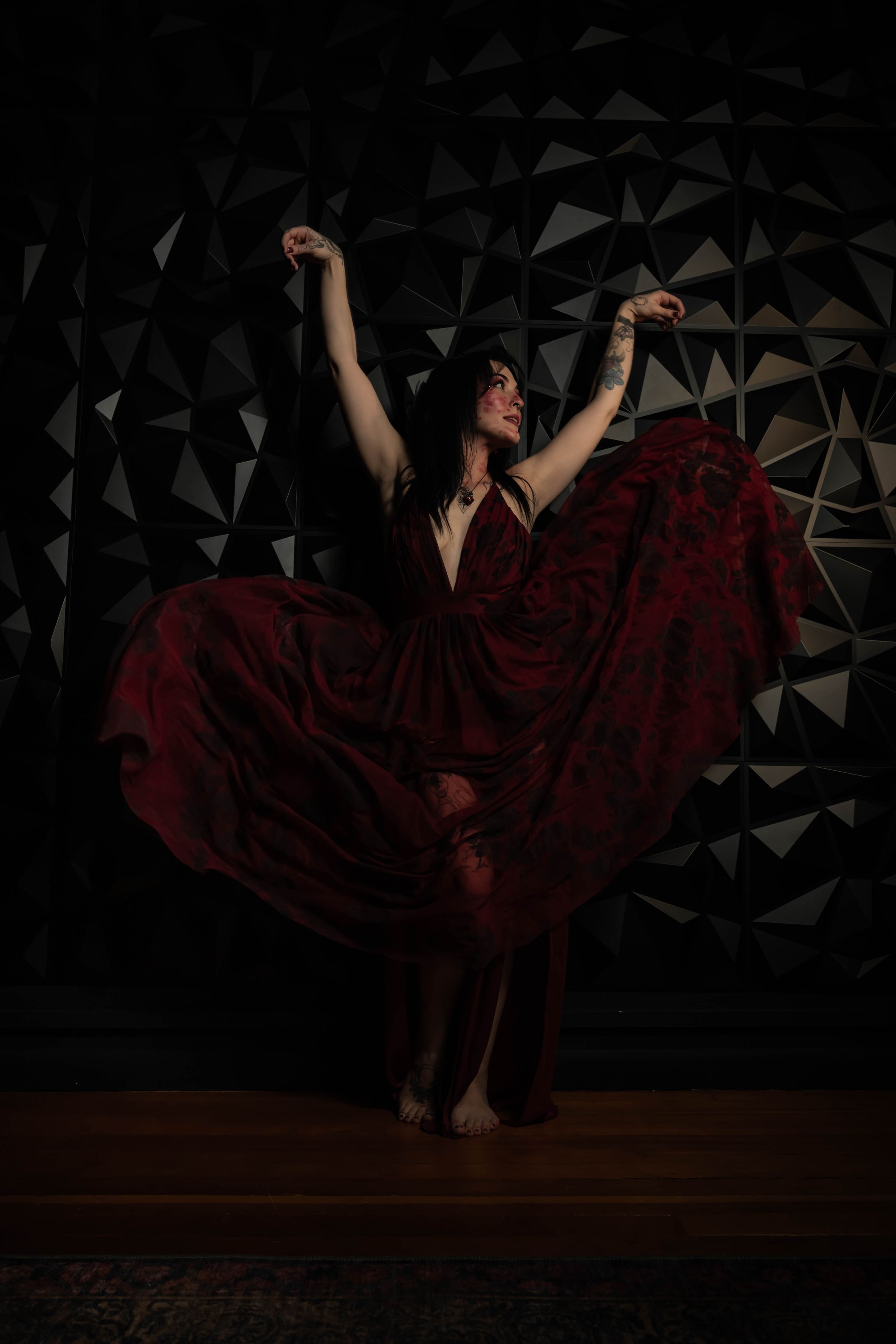 Dreamy fantasy photoshoot of a woman in a red flowy dress in a studio in Spokane Washington.