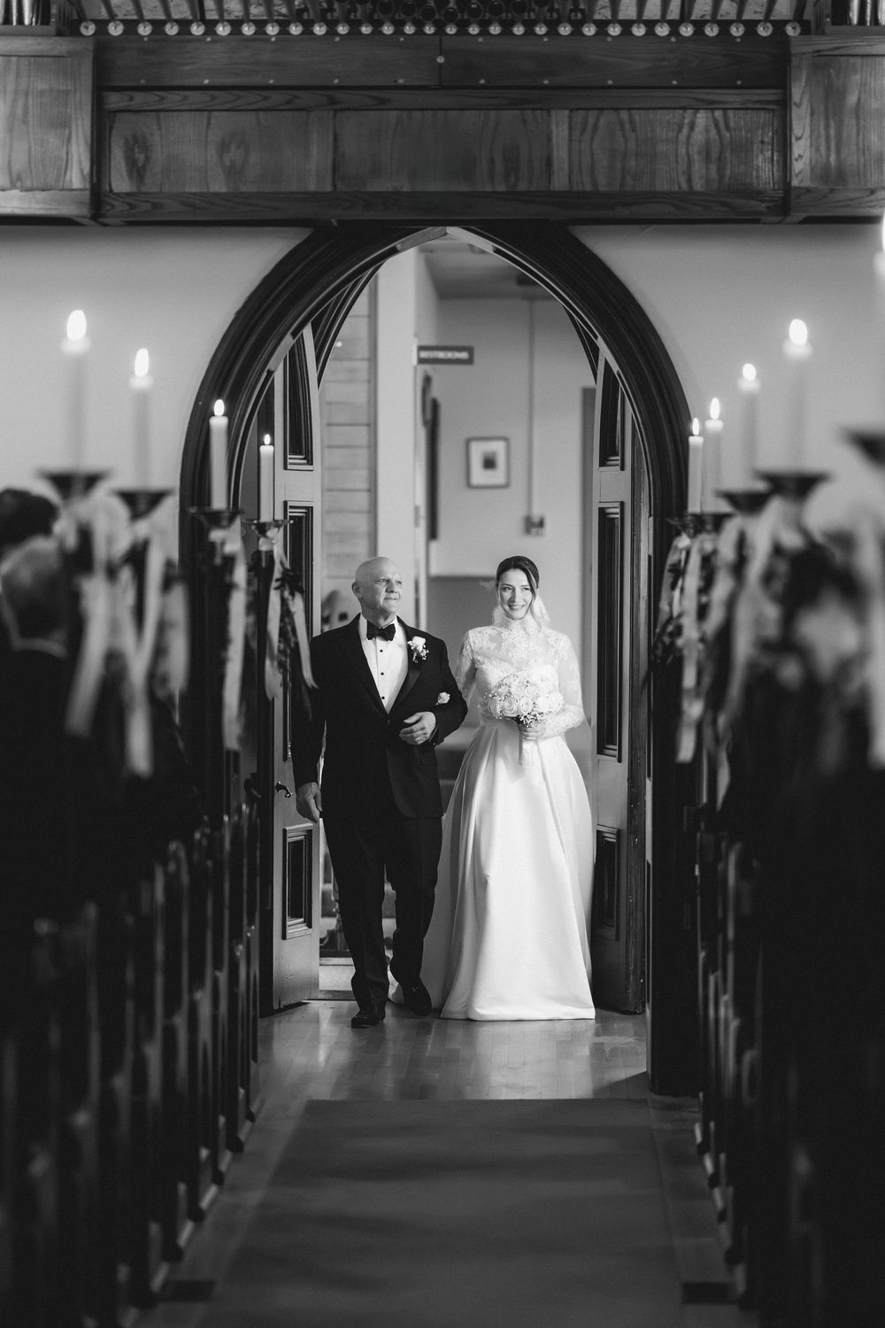 A sequence of black and white photos showing a bride walking down a church aisle in a traditional white wedding gown.