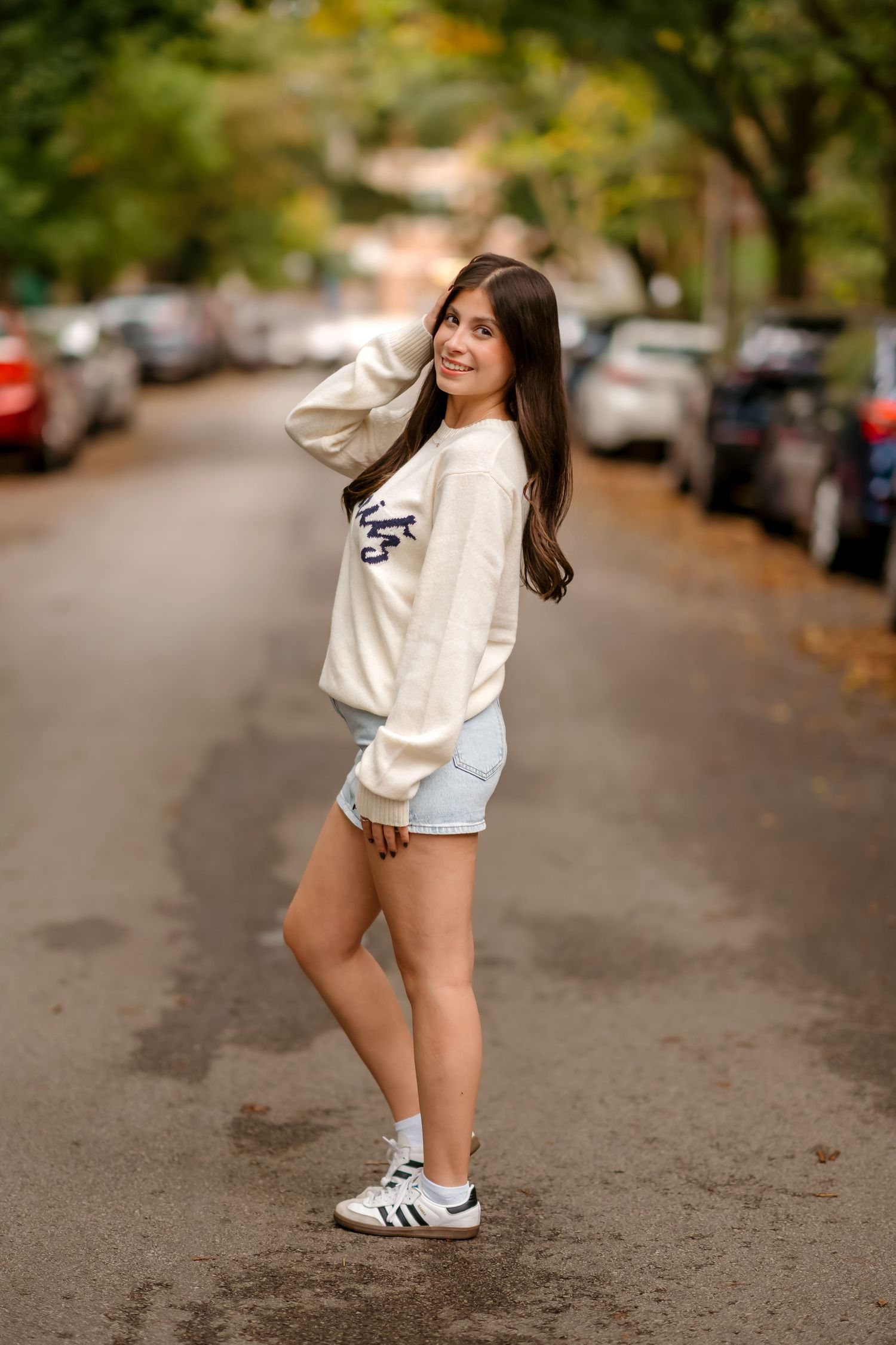 Casual street style photos showing playful poses in athleisure wear with white sneakers on autumn street.