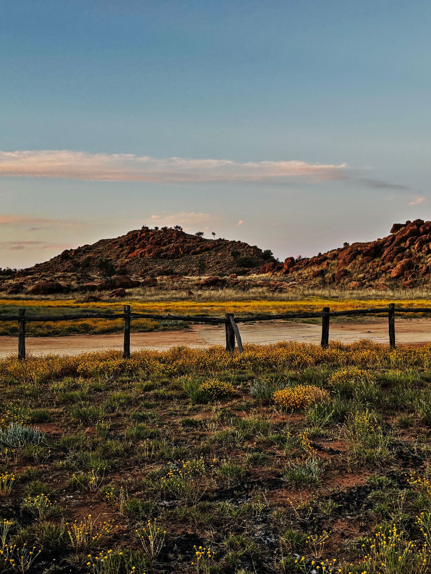 Alice Springs with the sun setting over dry land and large hills