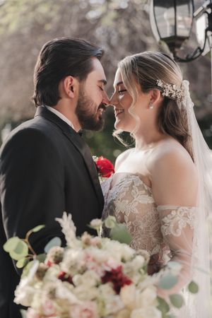 Romantic wedding couple shares intimate moments in a series of close-up shots with delicate floral bouquet details.