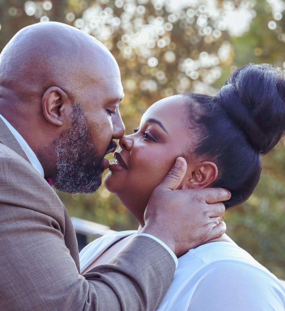 Romantic close-up of newlyweds sharing an intimate moment outdoors.
