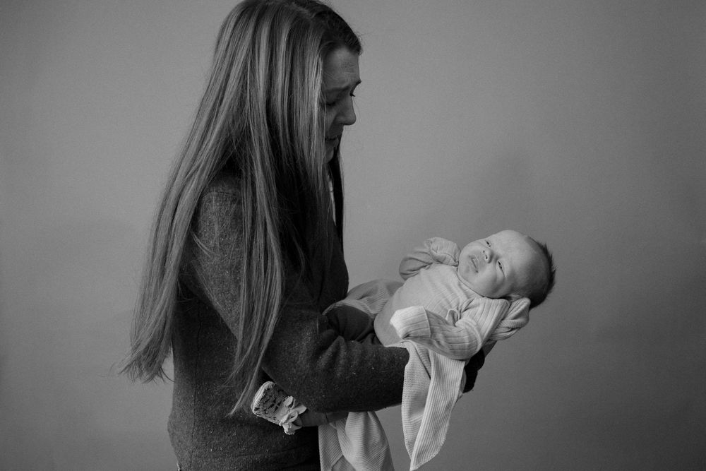 newborn studio session, black and white portrait, mom and baby