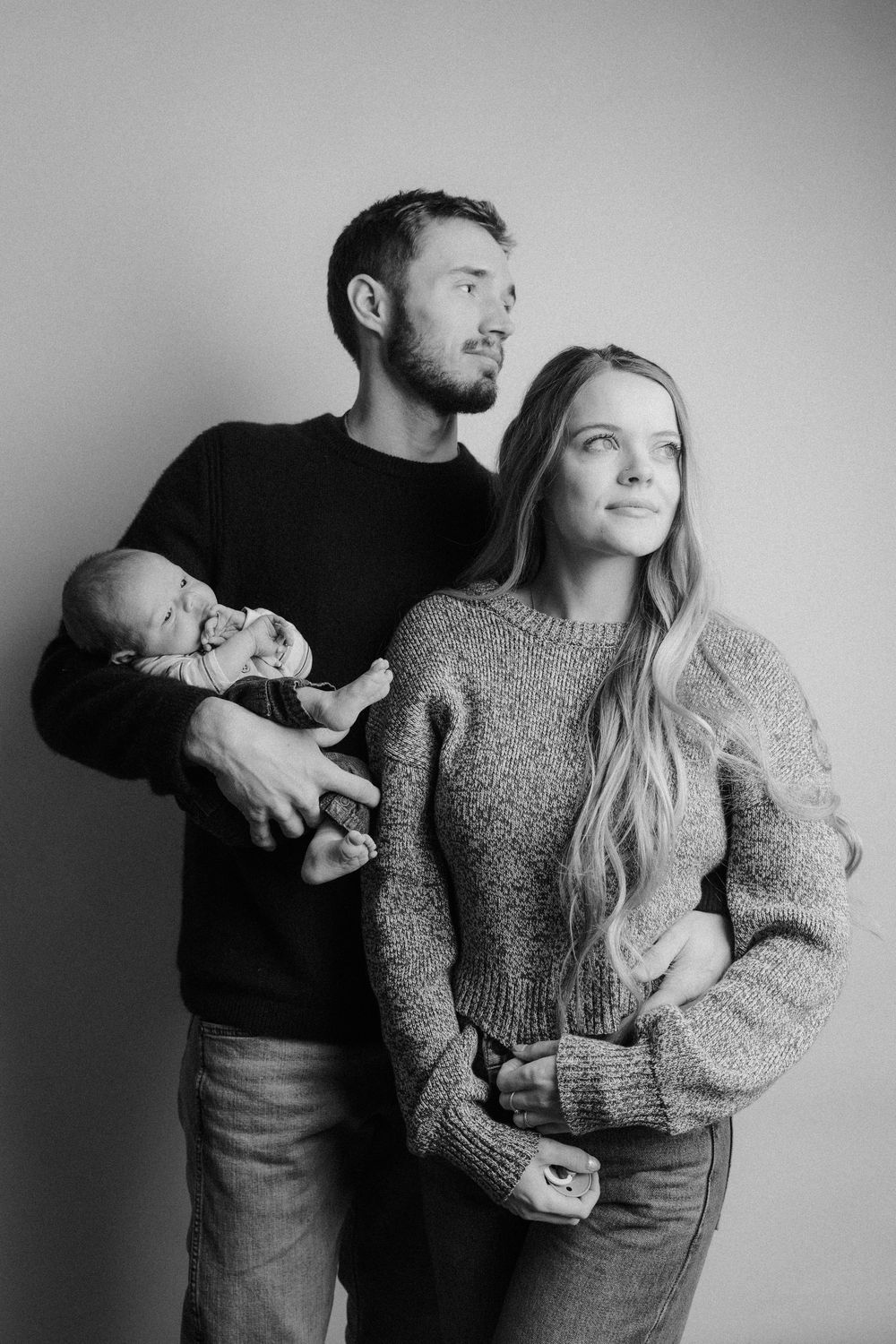 Black and white photo sequence showing couple in cozy sweaters posing playfully together.