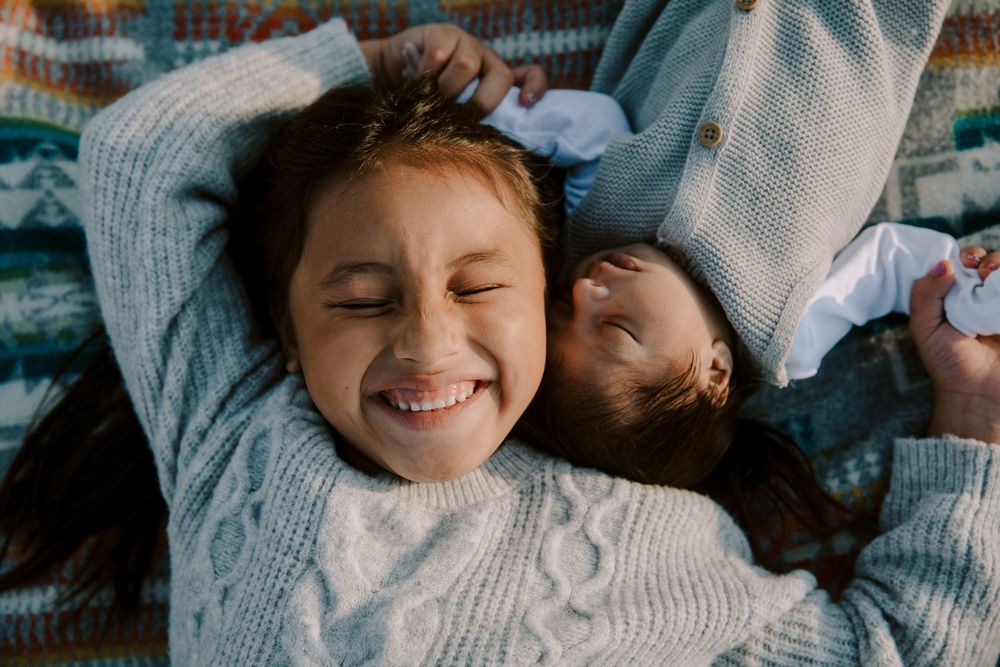 Intimate family moments captured in casual outdoor setting with joyful expressions.