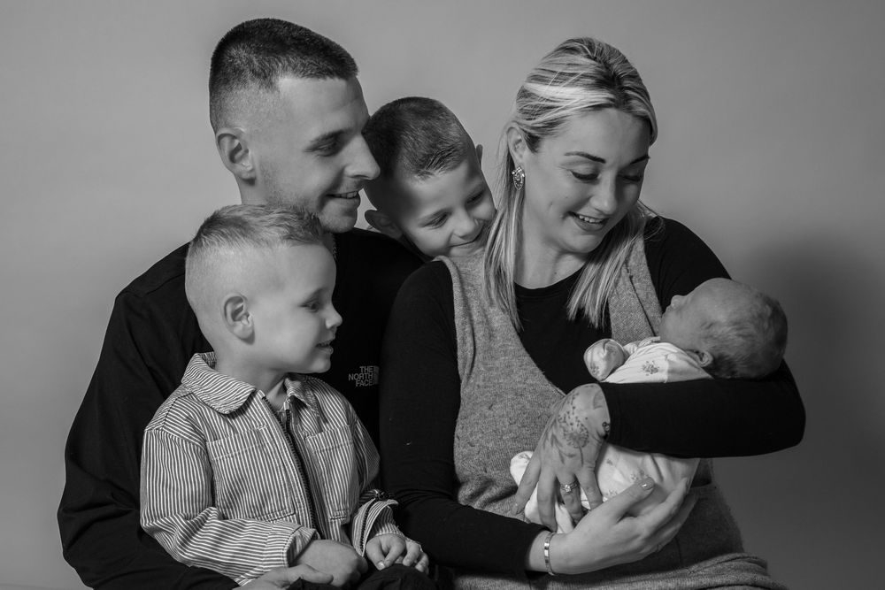 A series of black and white family photos showing tender moments between parents and children.