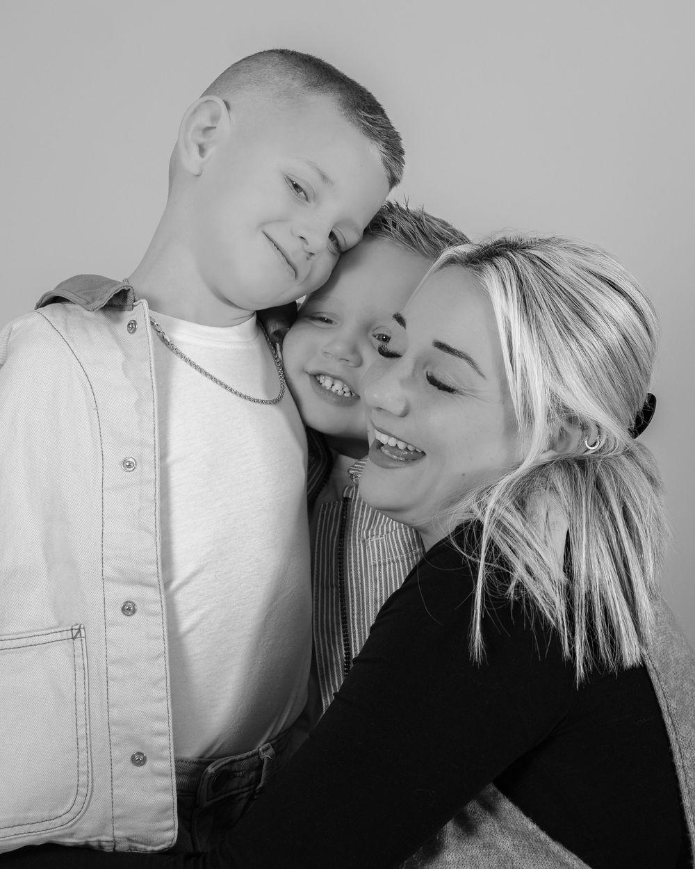 A tender black and white photo series showing intimate moments between two people in casual clothing.