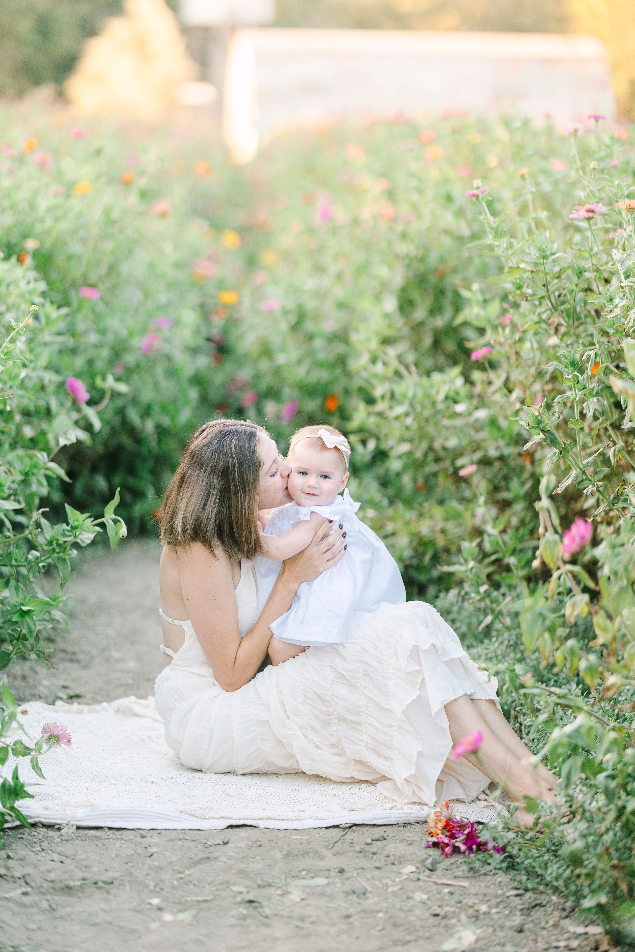 Sweet interactions captured in blooming garden with soft evening light.