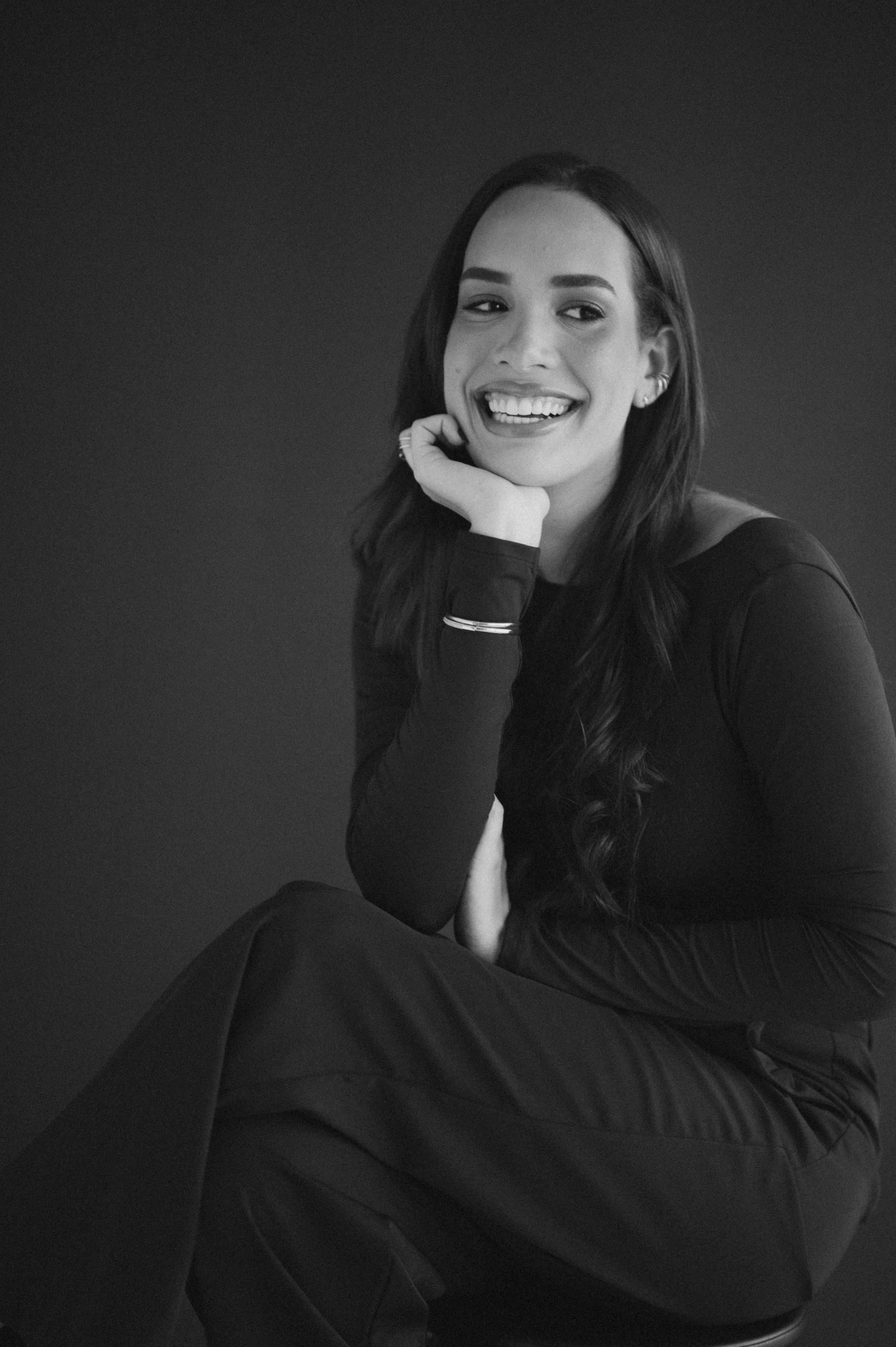 Black and white portrait series showing person in dark clothing with expressive poses against simple background.