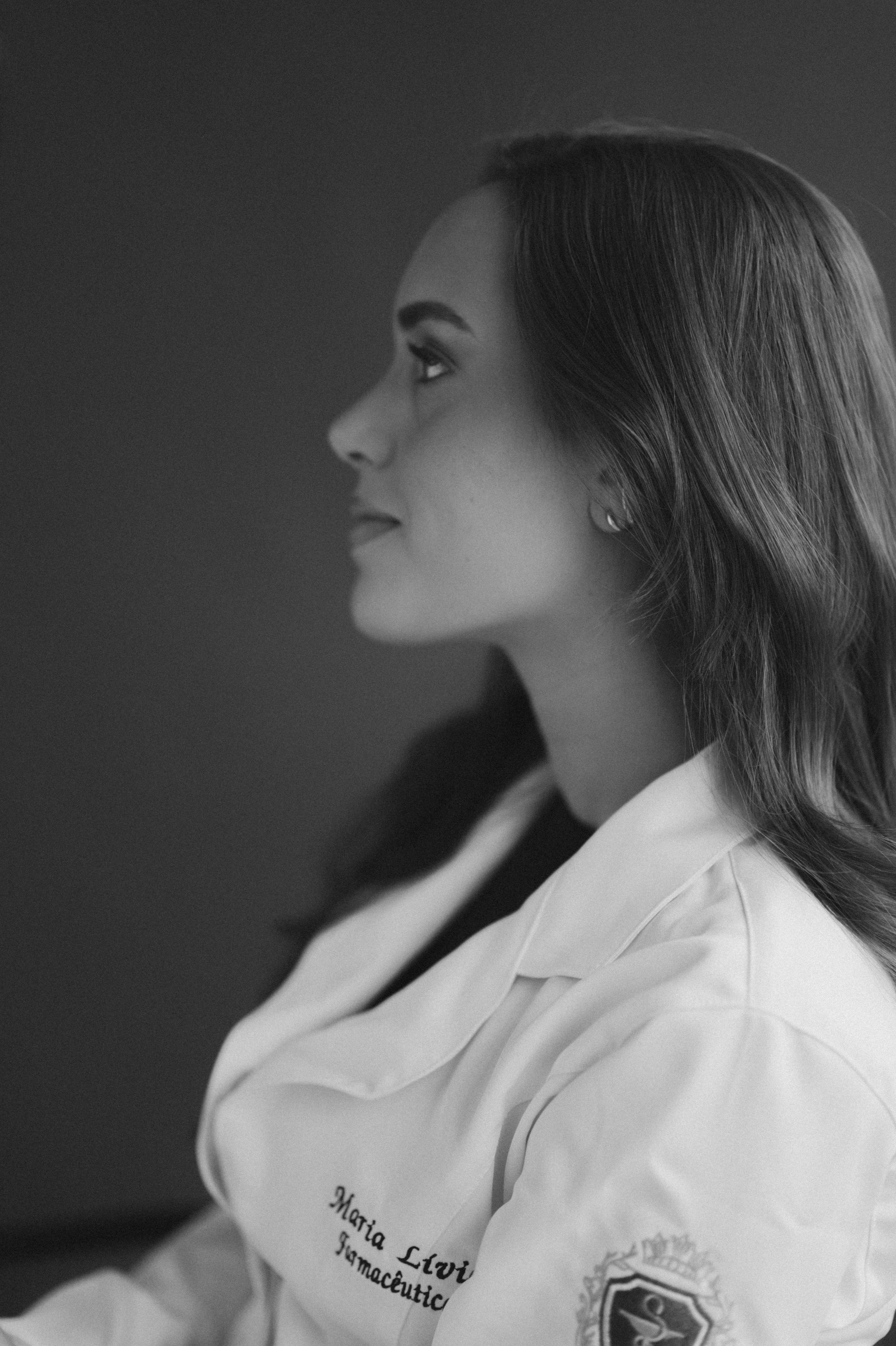 A black and white profile portrait series showing someone in a white collared shirt against a dark background.