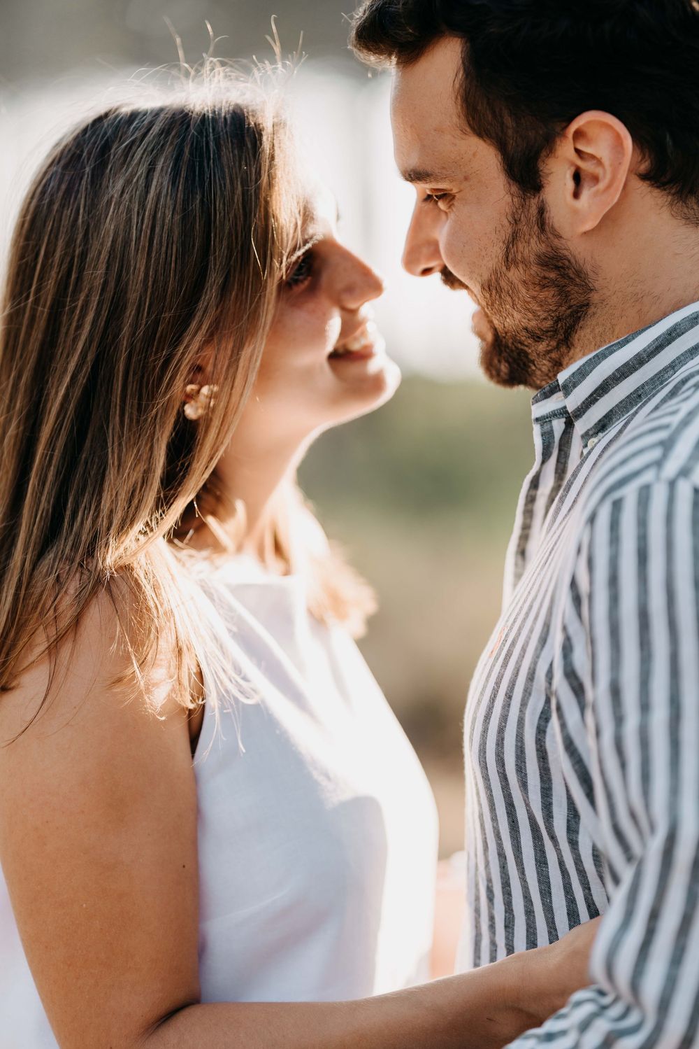 A romantic couple in sunlight share intimate moments in a series of close-up shots.