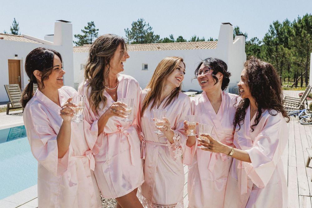 Bridesmaids helping bride during wedding morning in Portugal