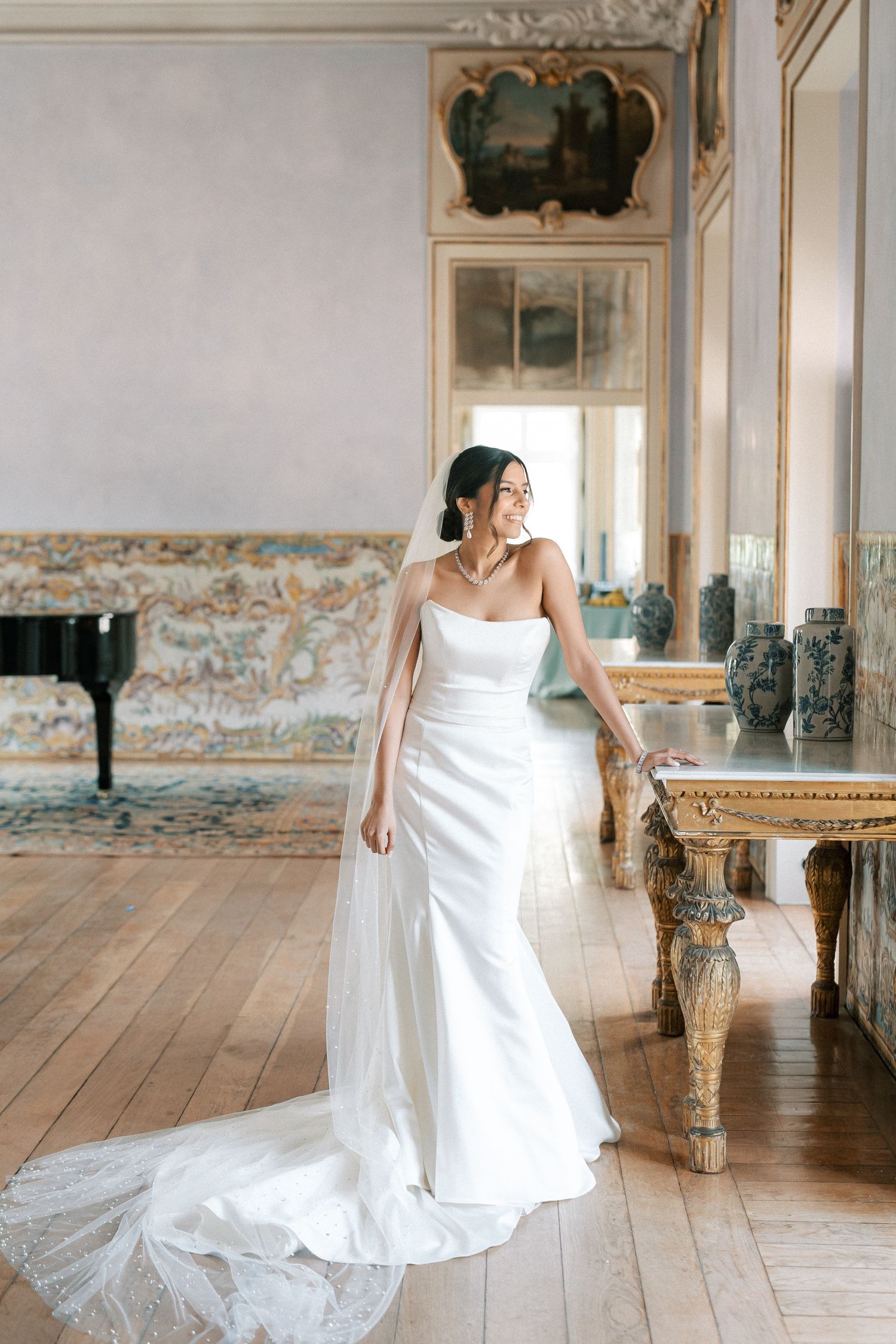 Bride in palace room with ornate mirror and tiles and golden furniture, Palácio de Fronteira Lisbon