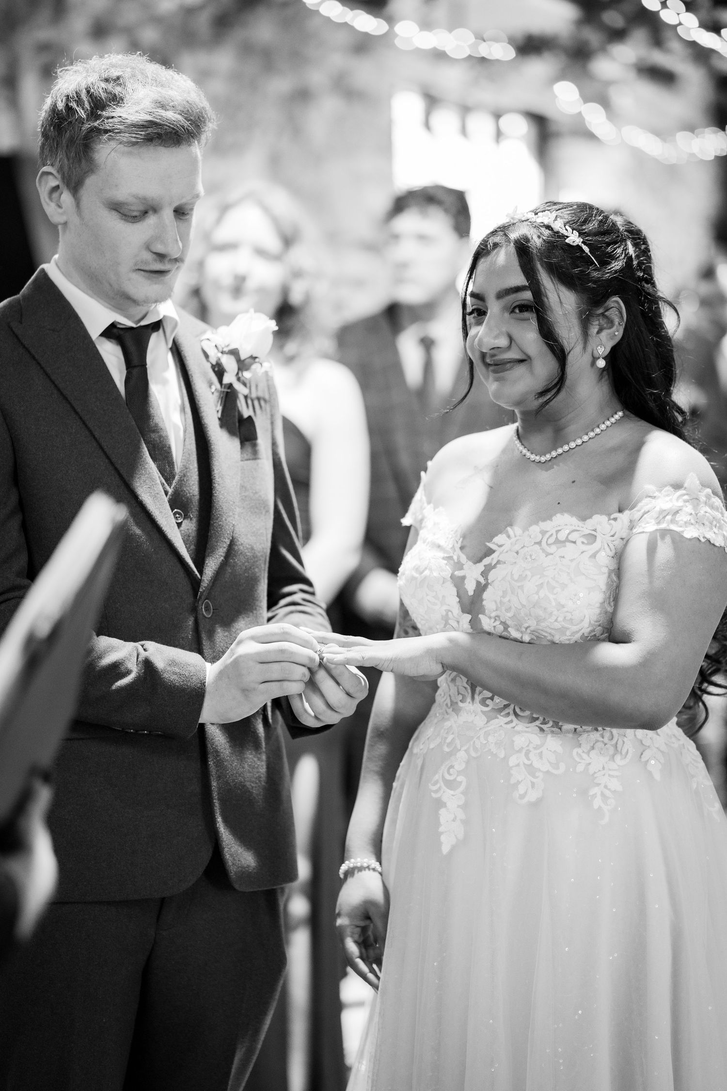 A romantic black and white photo sequence of a couple dancing together at their wedding celebration.