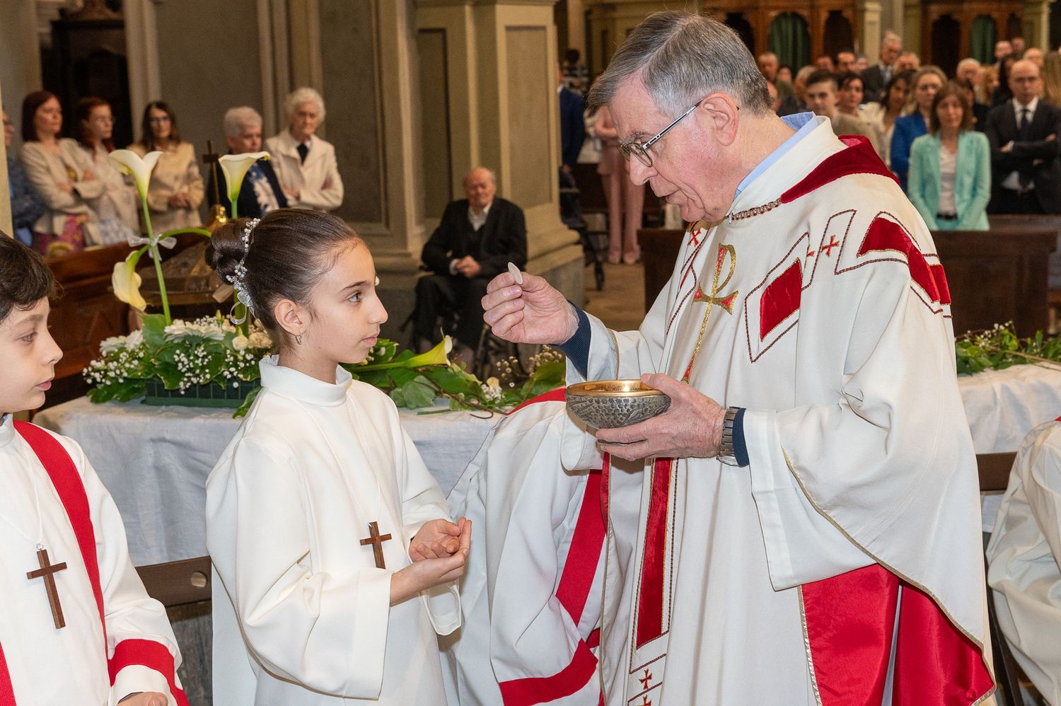 Communion ceremony in a grand church with clergy distributing sacraments.
