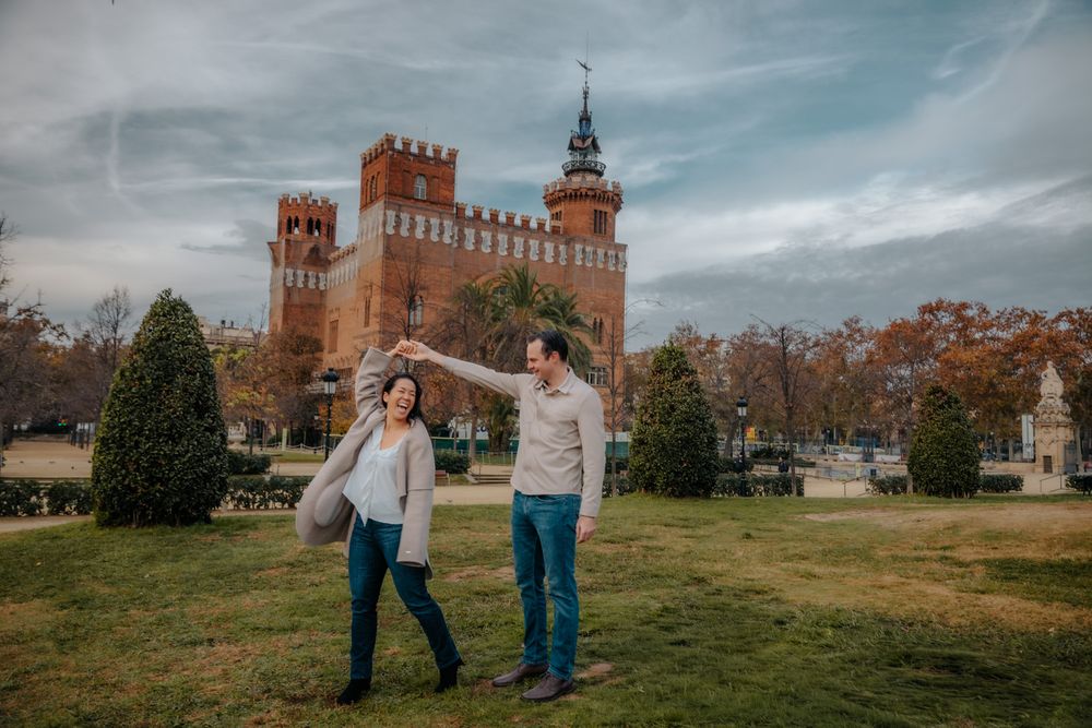 Playful couple descending fountain steps Barcelona Engagement photoshoot Barcelona BarcelonaLoversPH