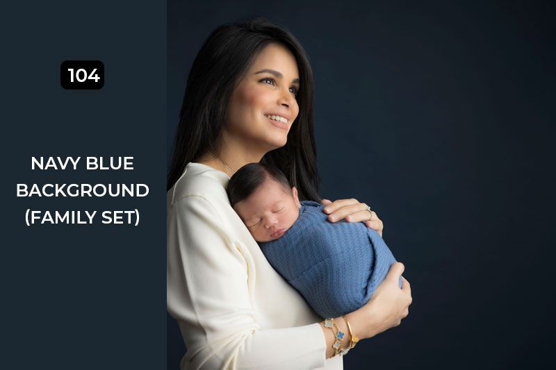 Stylish family photography set against a deep navy blue backdrop showing close embraces.