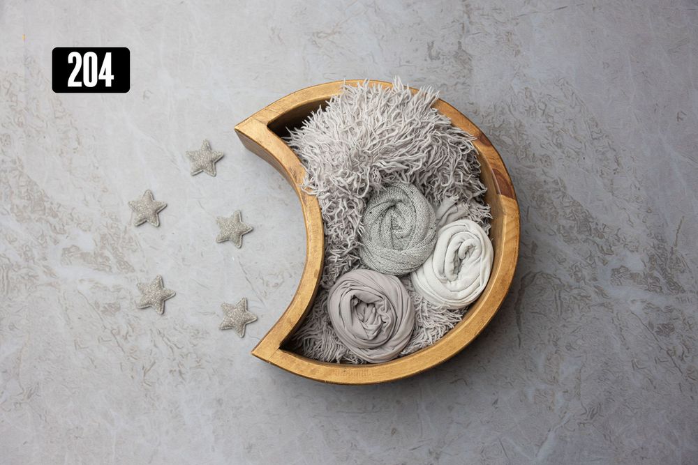 Wooden crescent moon bowl with rolled gray wraps and star decorations on gray background, newborn photography prop set 204.