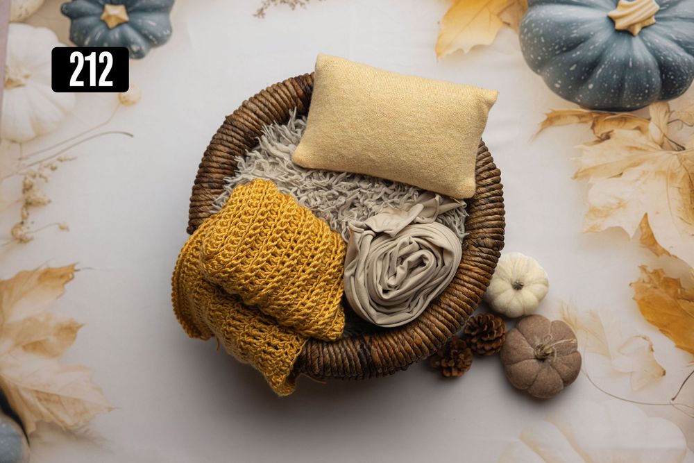 Autumn newborn photography prop set featuring a wicker basket with yellow knit wrap, cream layers, and a textured pillow, numbered 212.