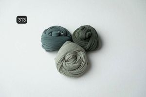 Sage green fabric wraps styled minimally on white surface.
